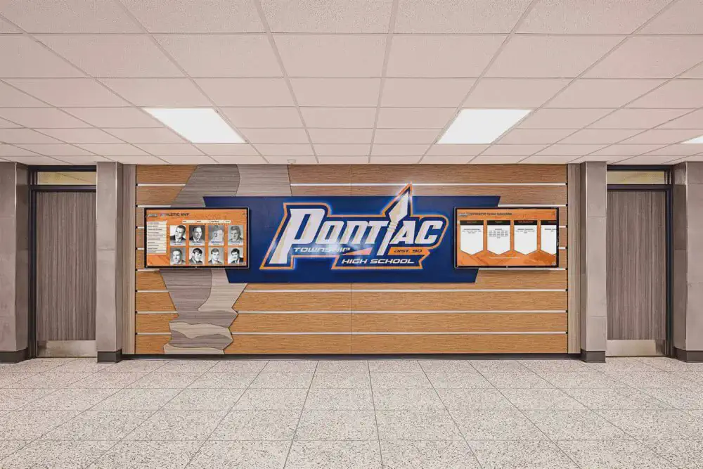 Two wall-mounted touchscreens showing athlete portraits and team banners around Pontiac's school name
