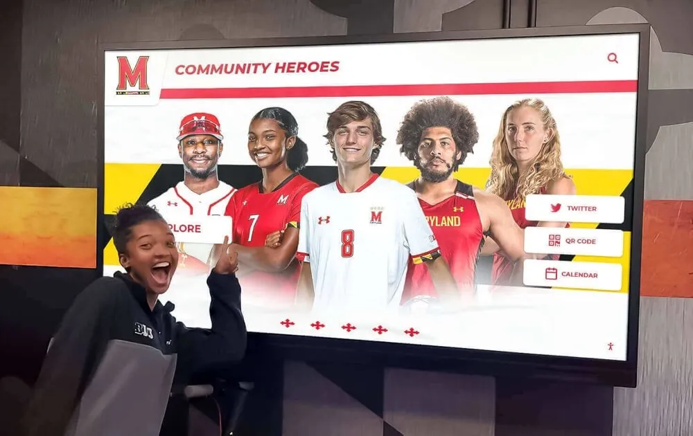 Students engaging with alumni display