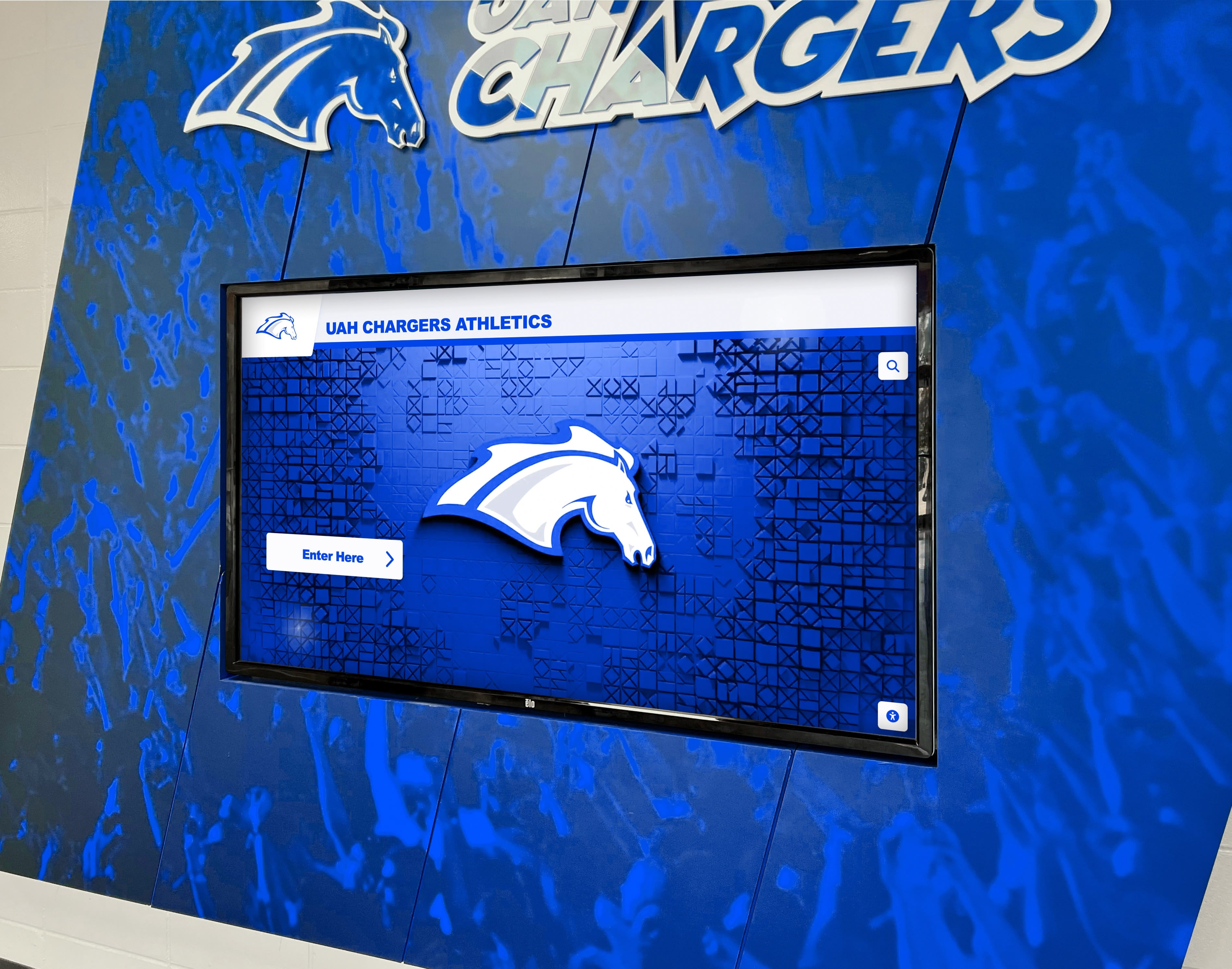 UAH Chargers athletics digital screen on blue wall Digital recognition display